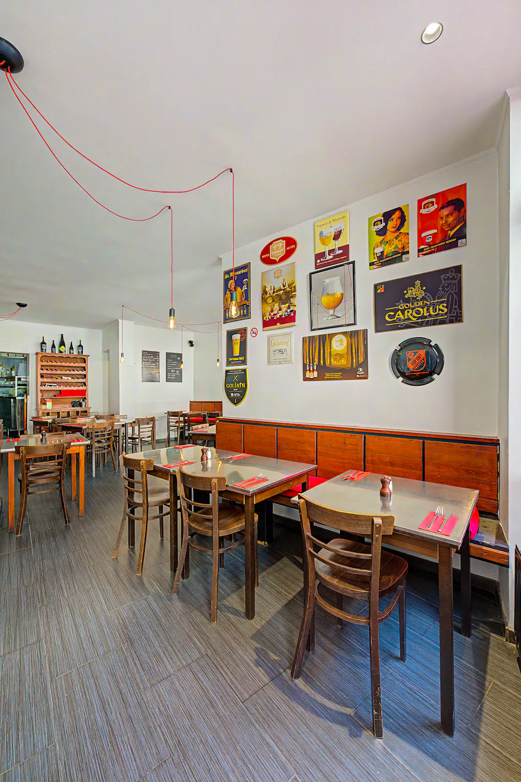 Big Mama’s bright dining room with vintage Belgian beer posters