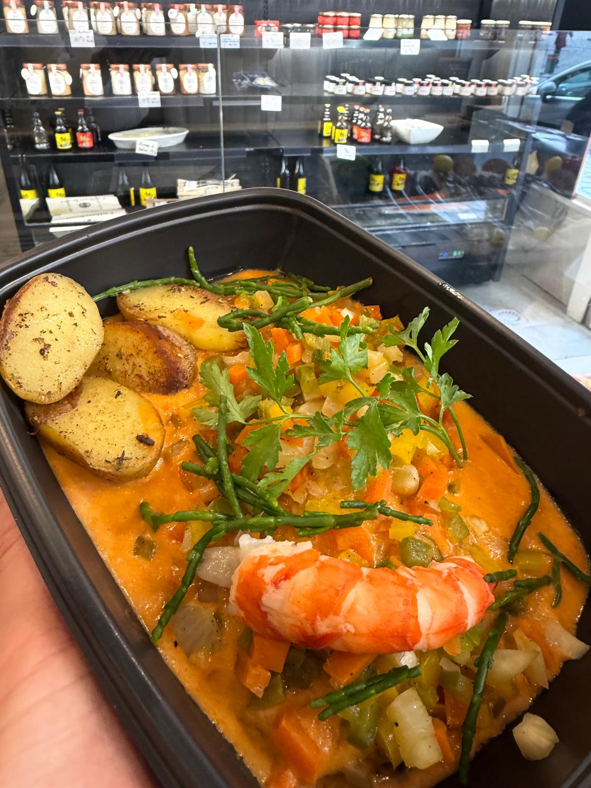 Scampi in bisque sauce with crunchy vegetables and baby potatoes