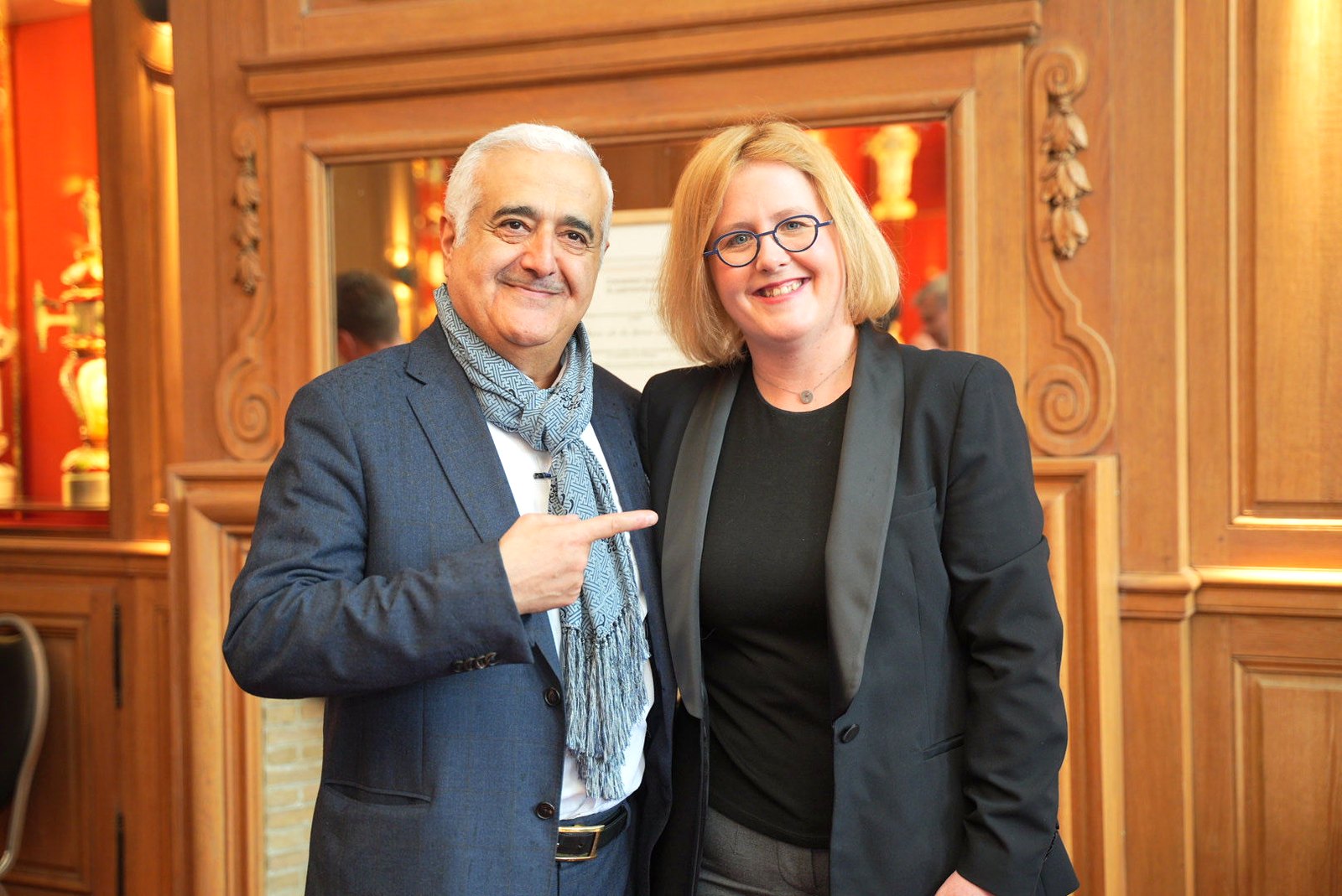 Two guests posing in the wood-panelled halls of the Brewers House on the Grand-Place