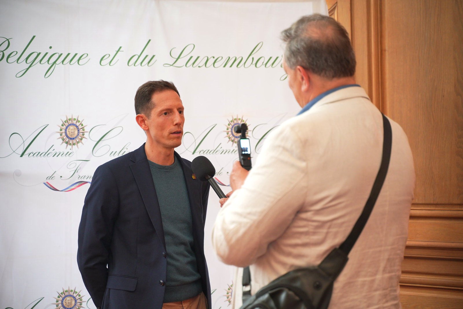 Interview in front of the Académie Culinaire de France Belgium and Luxembourg backdrop