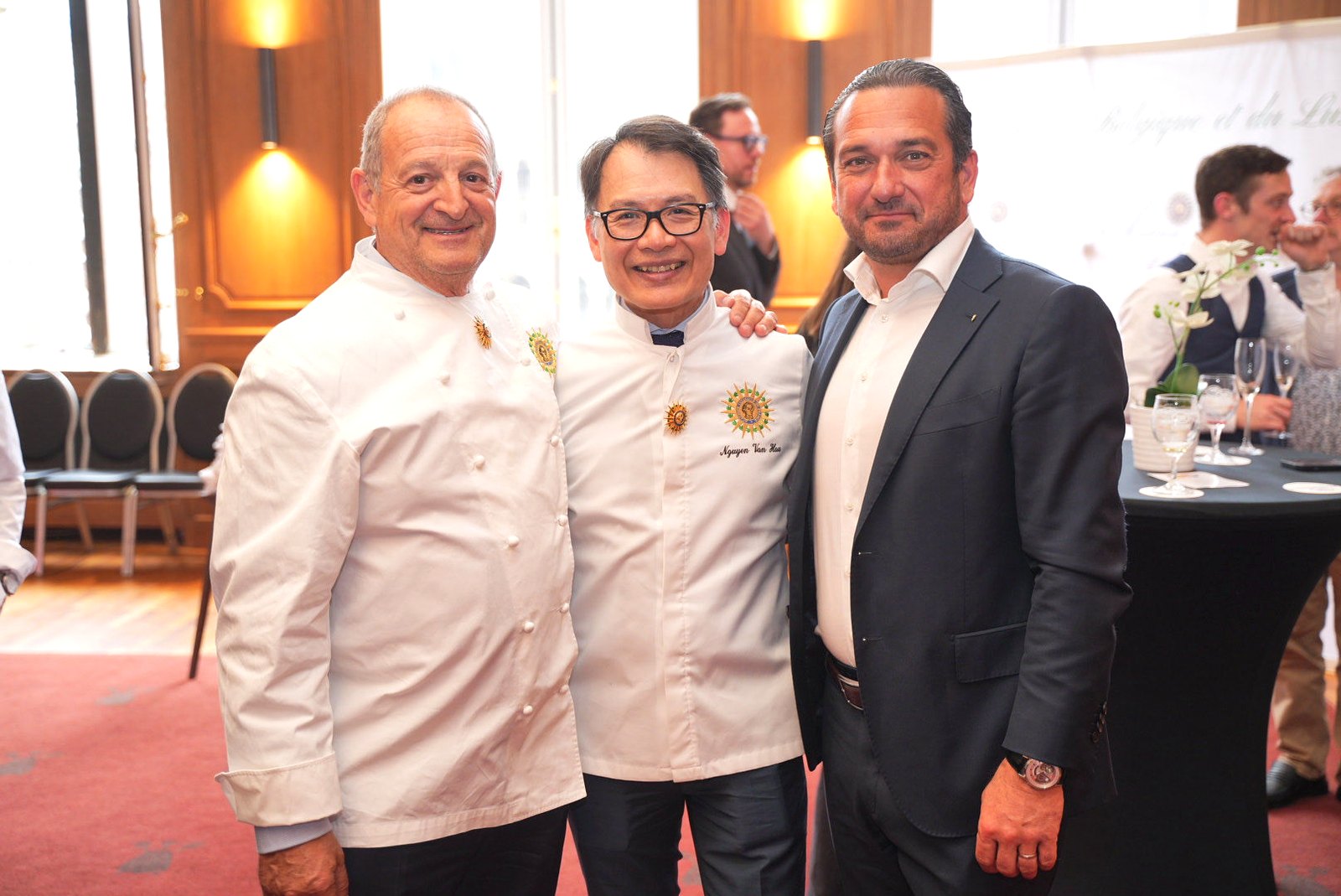 Chefs Yvan Roque and Nguyen Van Hau posing with a guest