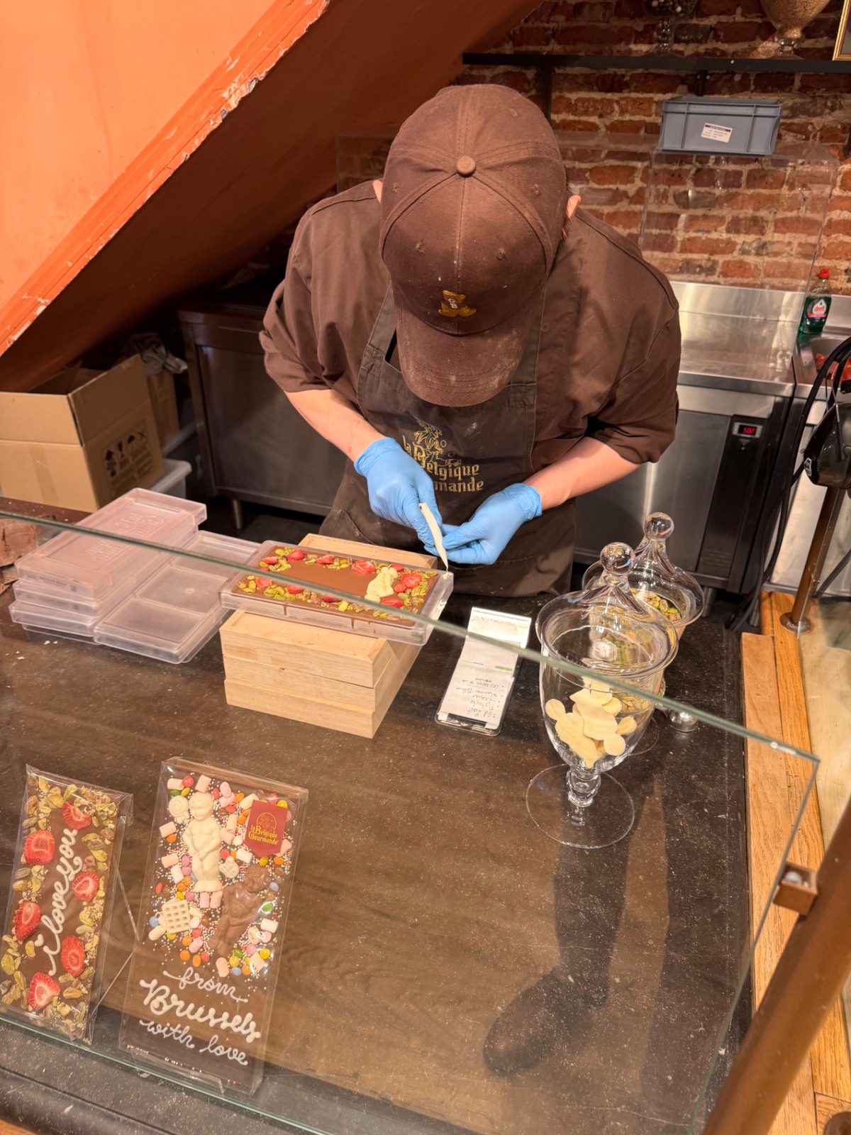 Finishing a chocolate bar with strawberries and pistachios
