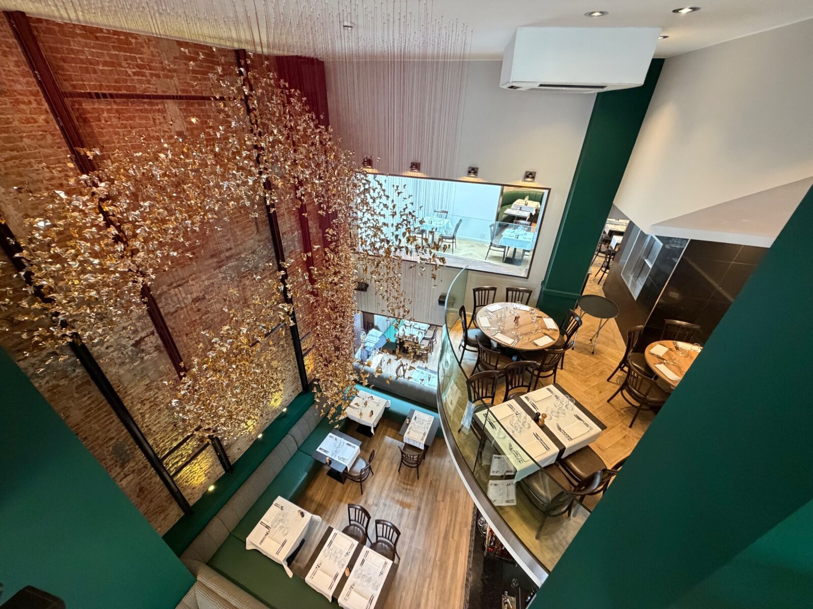 Atrium vertical d’Auguste avec l’œuvre dorée de Charles Kaisin sur toute la hauteur