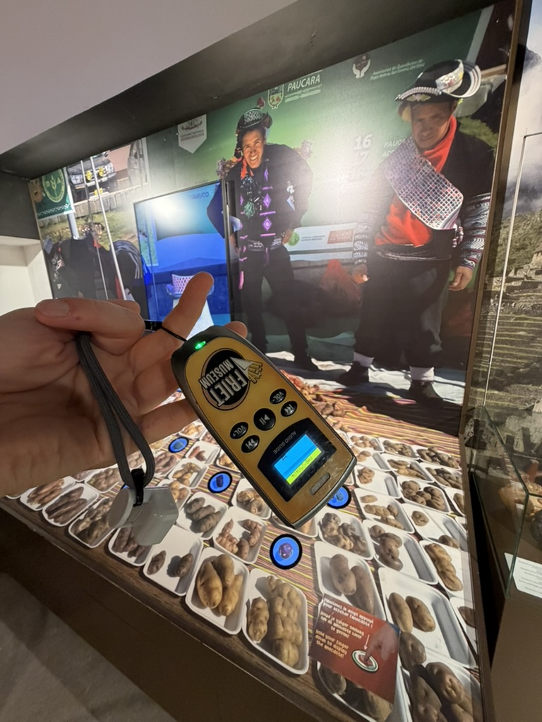 Visitor using the audio guide at an interactive Friet Museum display